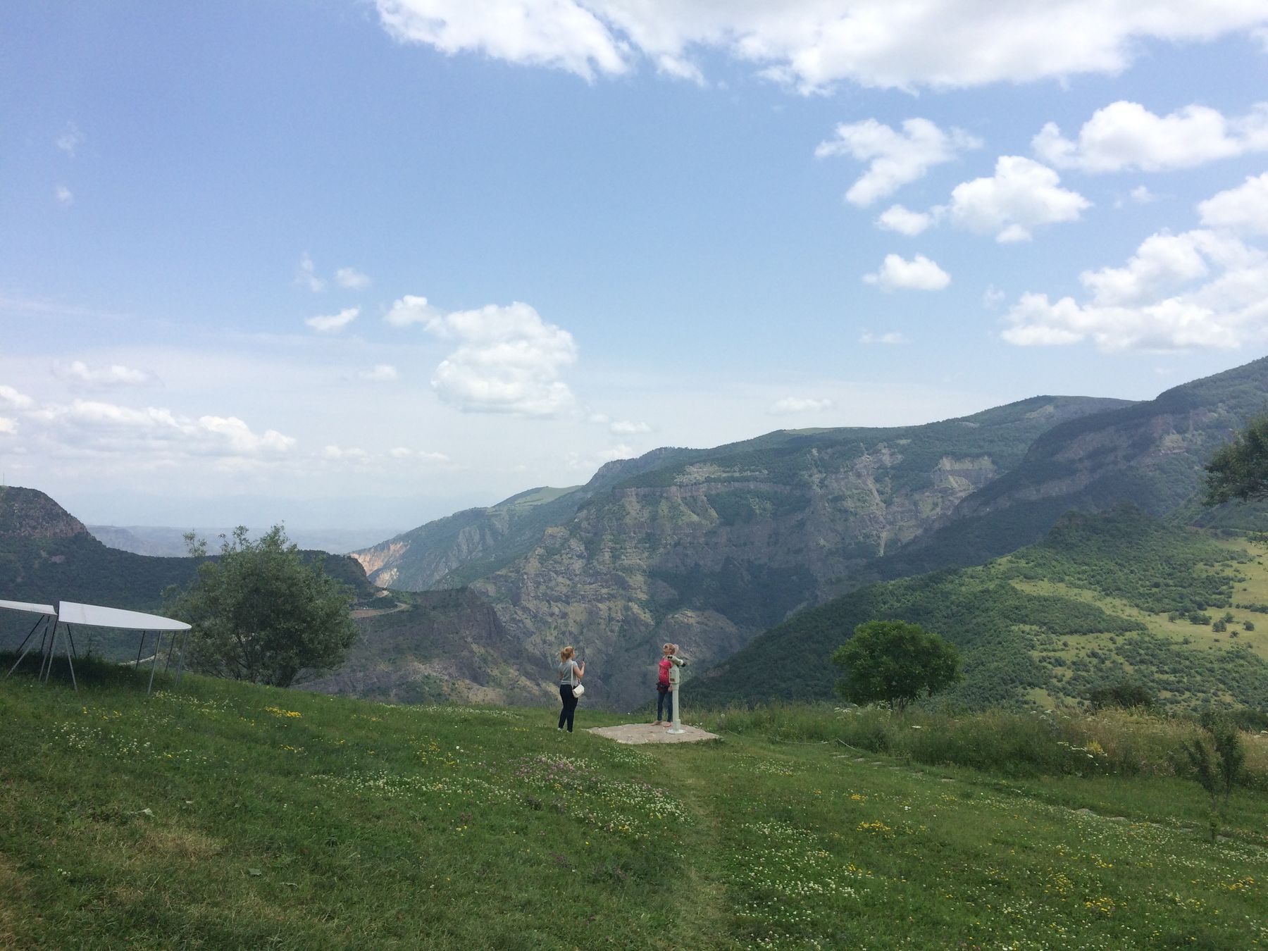A monastery on a ridge with mountains behind